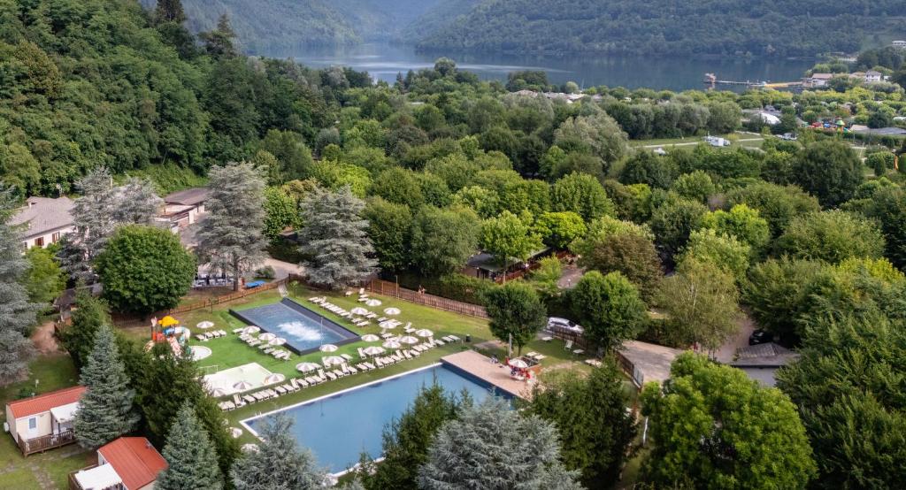 an aerial view of a resort with a pool and trees at Club del Sole Due Laghi Levico Family Collection in Levico Terme