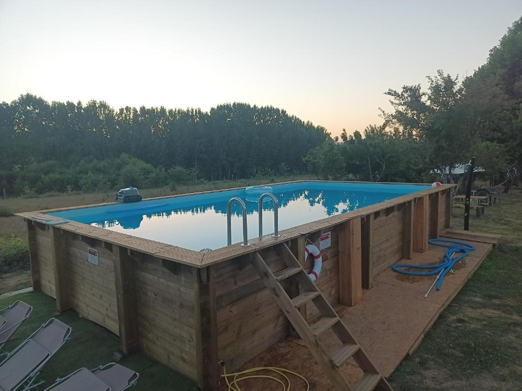 a pool with a wooden deck and a swimming pool at Casa da Avó Miquinhas in Paços de Ferreira