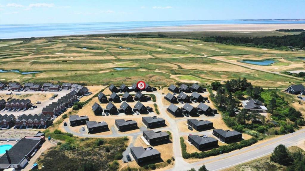 an aerial view of a resort with houses and the ocean at 0431-Romo-Vestergade-333 in Høm