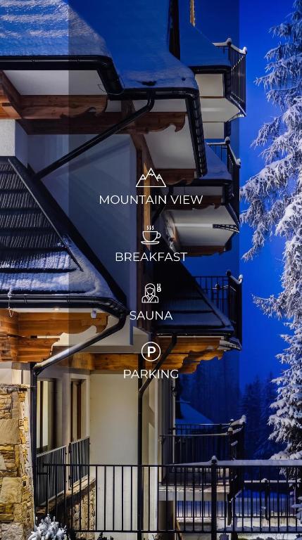a building with signs on the side of it at Villa Taternik by Golden Apartments in Zakopane