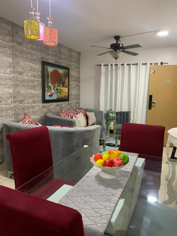 a living room with a bowl of fruit on a glass table at Casa Mamá Tere in Pantoja