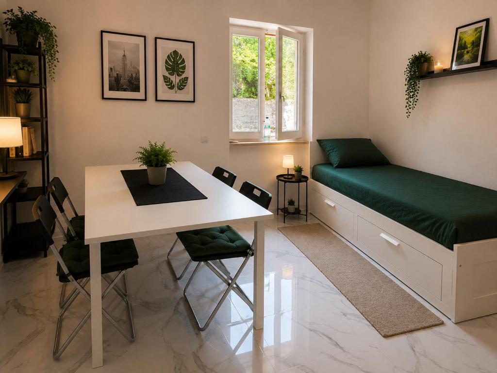 a room with a bed and a table and chairs at Leonardo Loft in Filettino