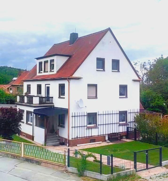 a large white house with a red roof at Ferienwohnung Talblick Wilthen in Wilthen