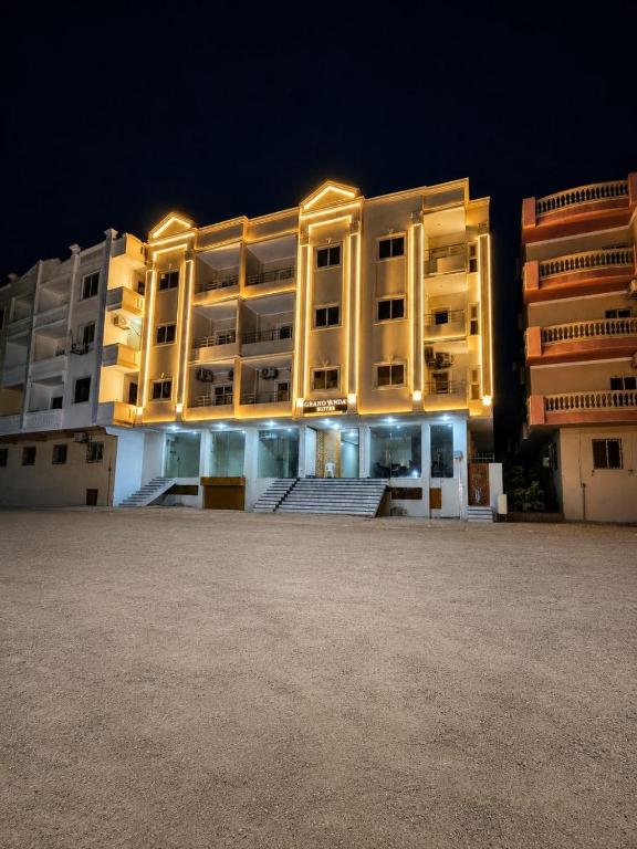 a large apartment building at night with its lights on at جراند فاندا سويتس الغردقه Grand Vanda Suites Hurghada in Hurghada