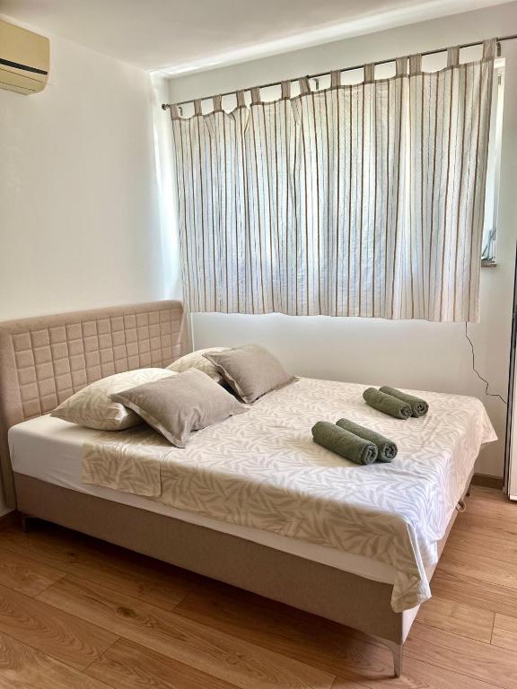 a bed with two pillows on it in a bedroom at Marica & Kata in Vrgorac