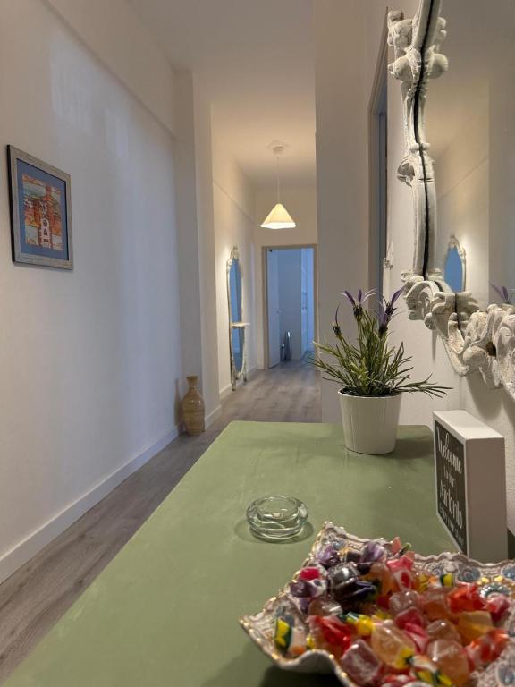 a room with a green table with candy on it at AuraHouse in Mignanego