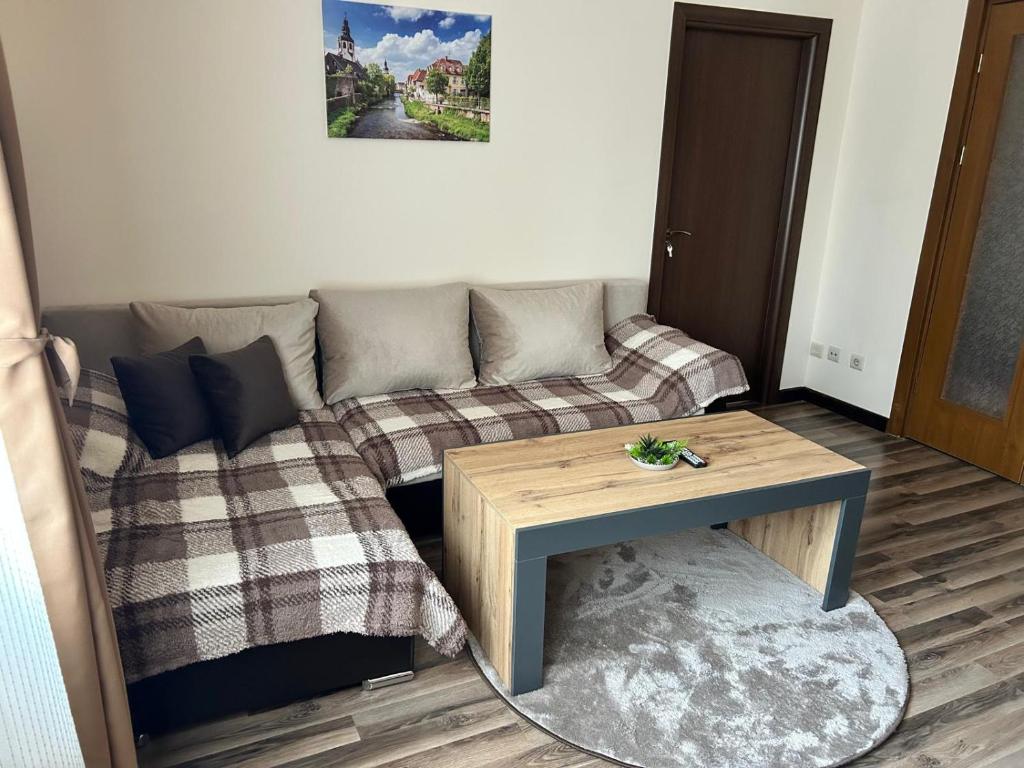 a living room with a couch and a table at Central apartment in Razlog