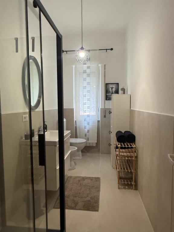 a bathroom with a sink and a toilet and a mirror at AuraHouse in Mignanego