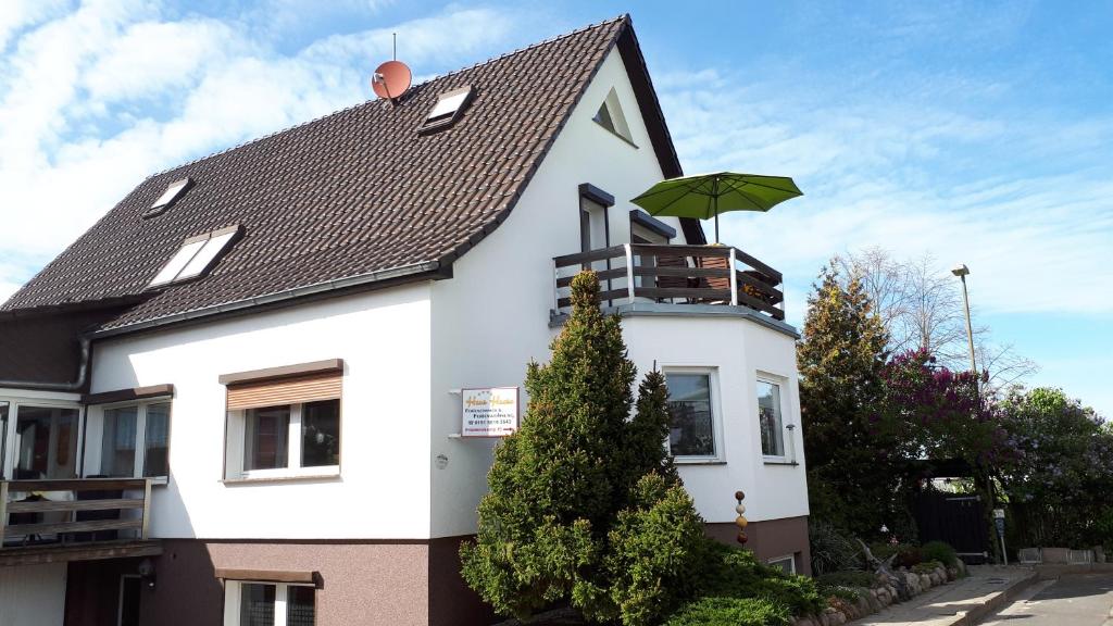 a white house with an umbrella on top of it at Haus Haase in Prenzlau