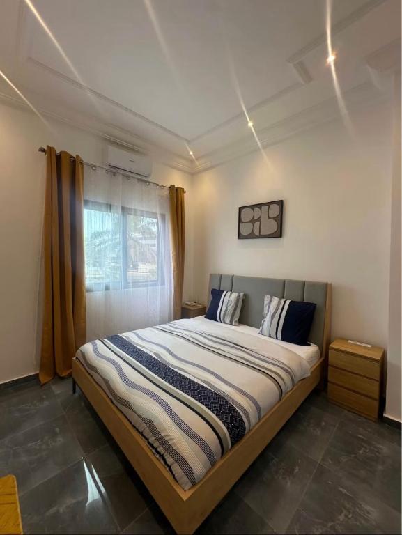 a bedroom with a large bed with a window at Bk House in Pointe-Noire