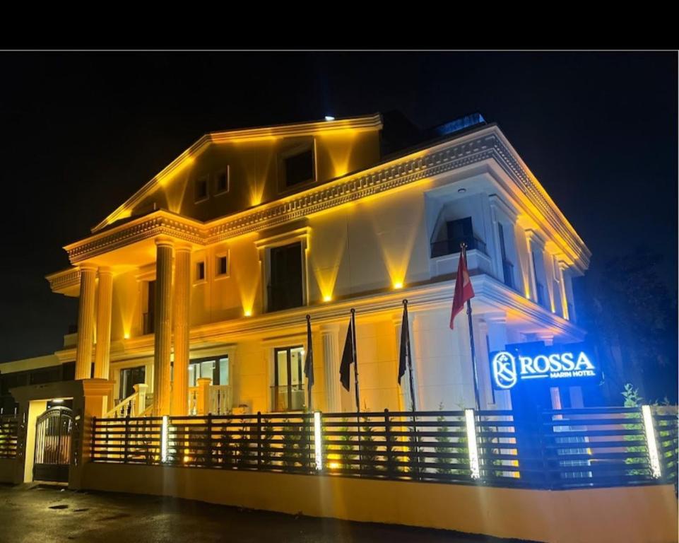 a large white building with lights on it at night at Rossa Marin Hotel in Darıca