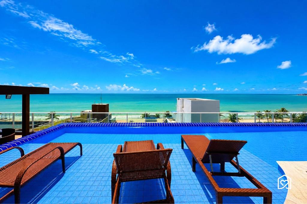 a swimming pool with a view of the ocean at Mar Bello in Ilha da Restinga