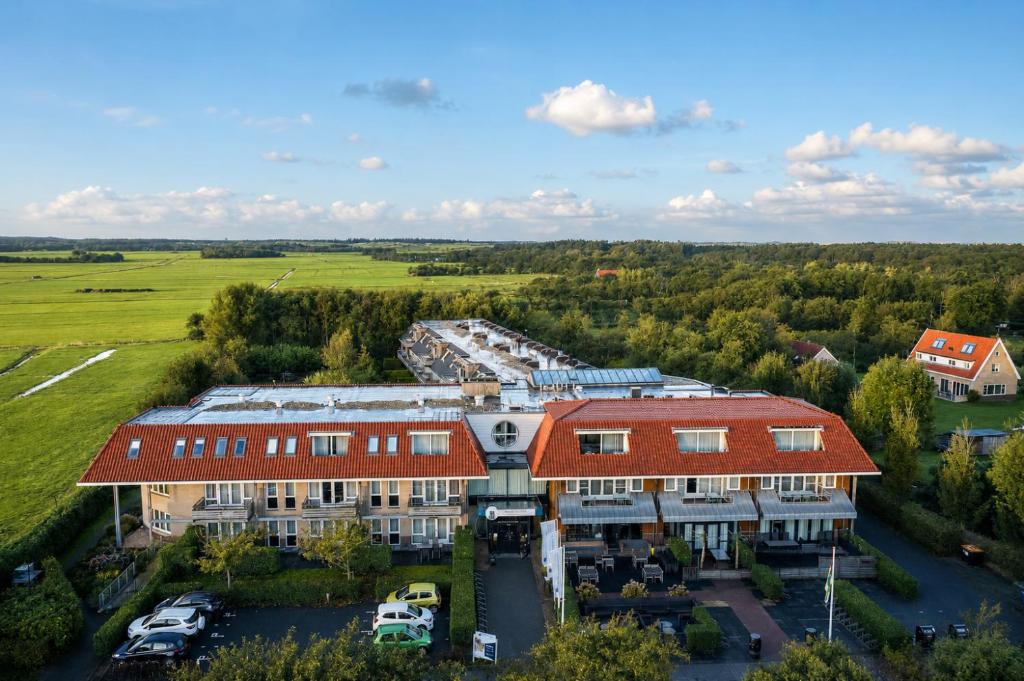 an aerial view of a large building with a parking lot at Residence Terschelling Wellness Waddenresort in Midsland