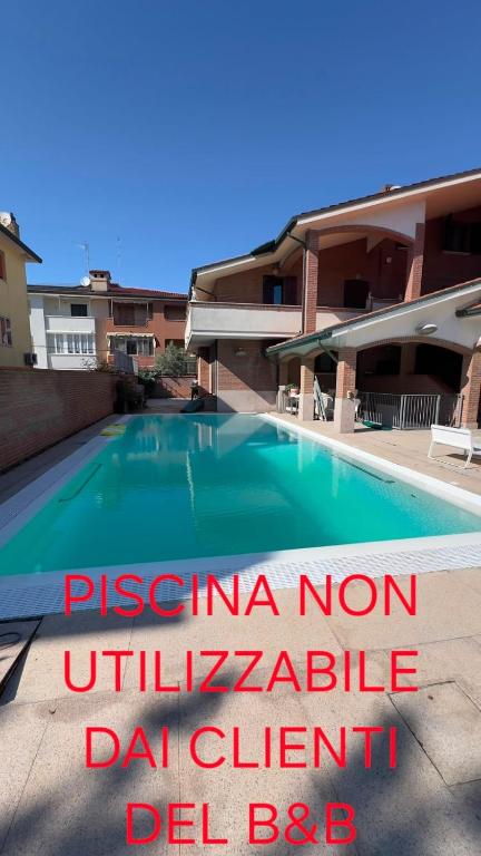 a sign in front of a swimming pool at B&B La Pitagora in Porto Garibaldi