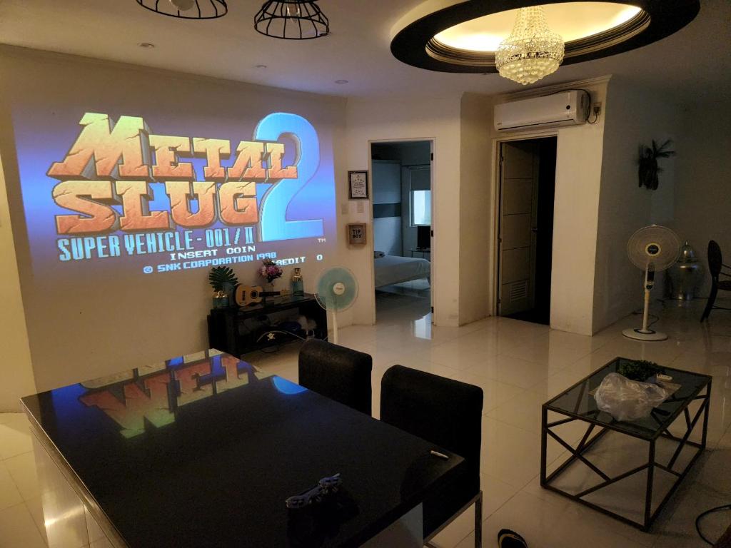 a dining room with a table and a sign on the wall at Lucky Suite Kandi 2 bedrooms in Angeles