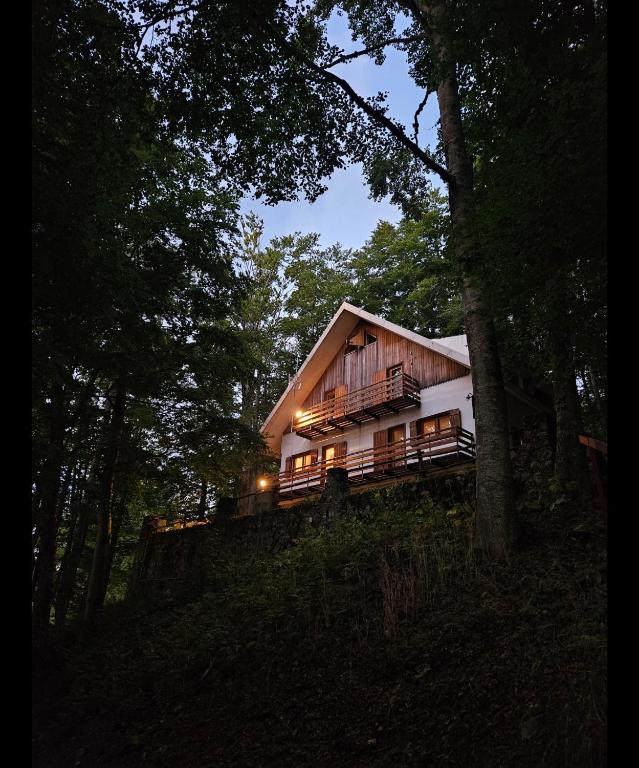 a house sitting on top of a hill in the woods at Baita degli Alpini in Terminillo