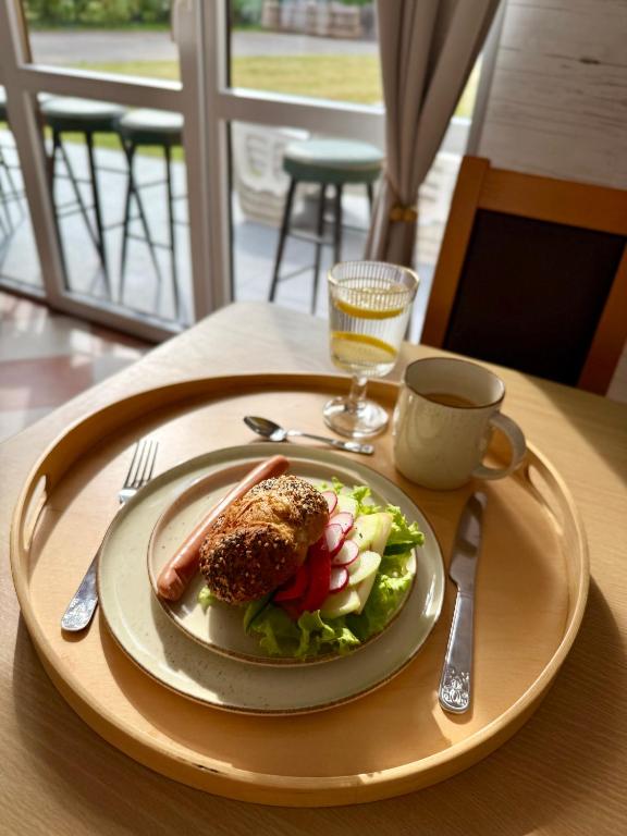 a plate of food and a cup of coffee on a table at Pokoje Alina, 500m do morza ze śniadaniem in Grzybowo