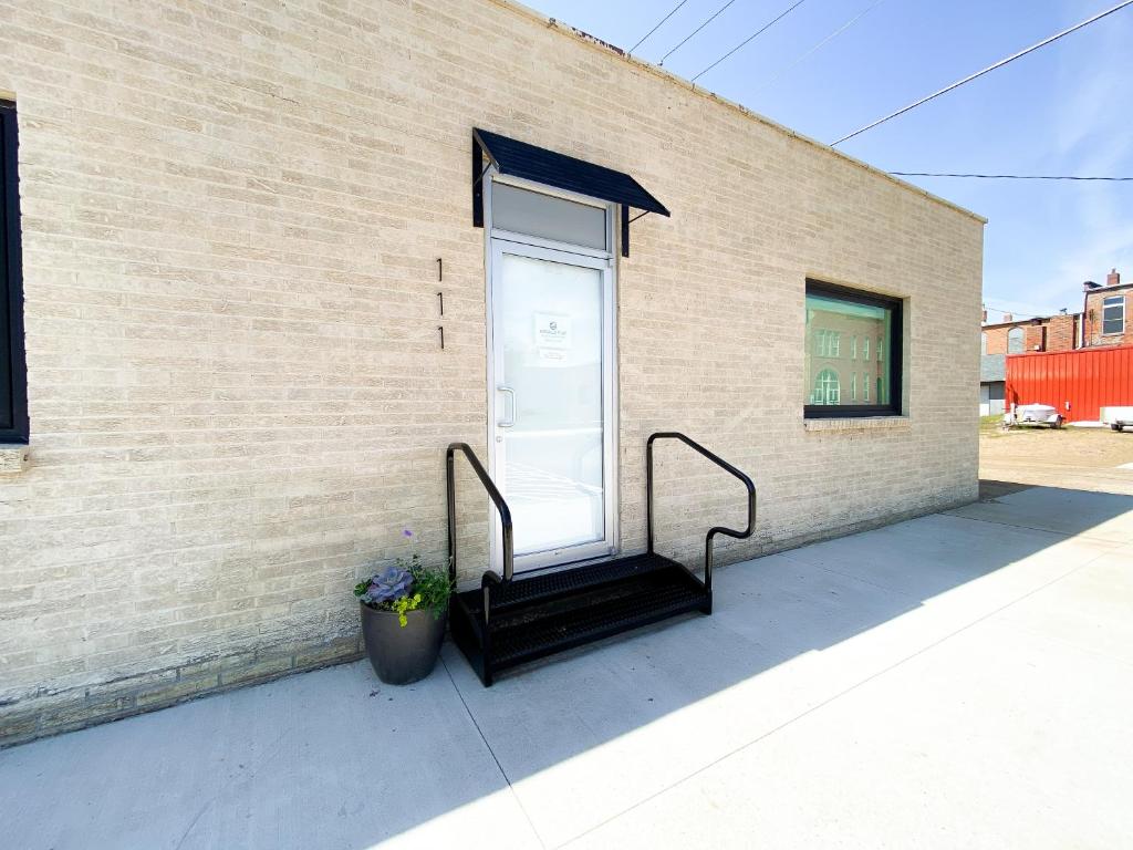 a building with a glass door and stairs on it at Ingalls Flat in De Smet