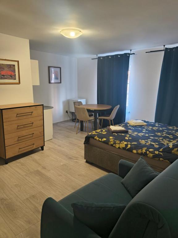 a bedroom with a bed and a desk and a table at Przy Żelaznym Moście in Kłodzko