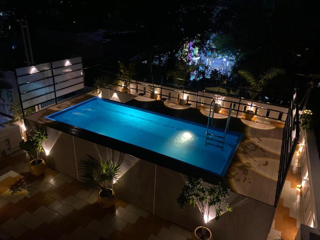 an overhead view of a swimming pool at night with lights at Villa Shakthi in Pondicherry