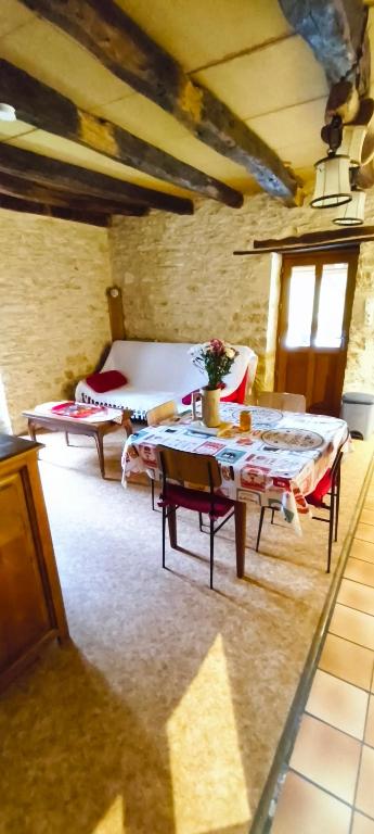 a room with a bed and a table in a room at Gîte d'Alithe in Montamel