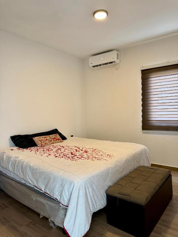 a bedroom with a large bed and a window at Manzanillo Homestay Room in Manzanillo
