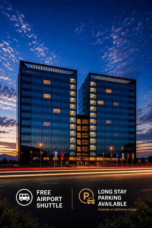 two tall buildings in a city at night at Premier Sofia Airport Hotel in Sofia