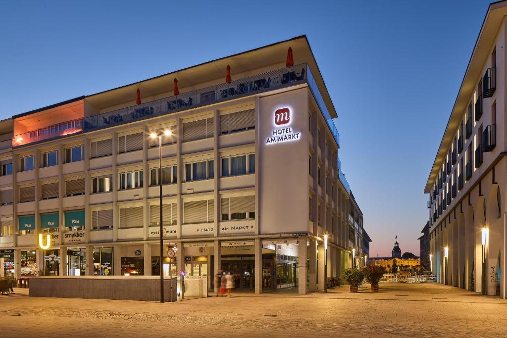 a large building with a sign in front of it at Hotel Am Markt in Karlsruhe