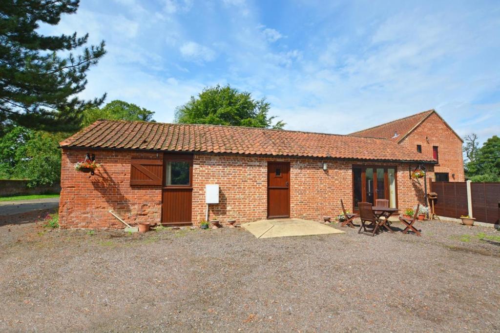 a small brick house with a large yard at 2 Bed in Lyng oc-864 in Lyng