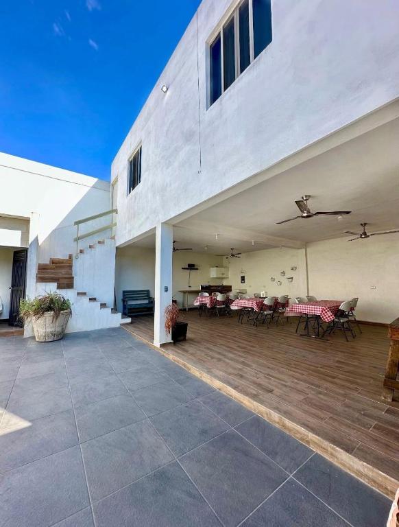 a large patio with tables and chairs and a building at Casa Tulipán in Monterrey