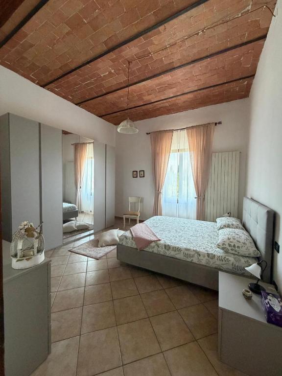 a bedroom with a large bed with a wooden ceiling at Del Rio Palace Guest House in Certaldo