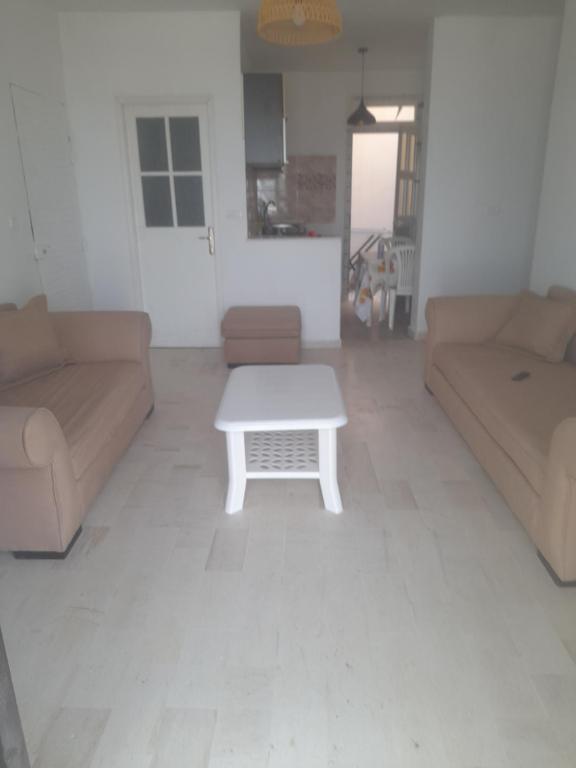 a living room with two couches and a coffee table at Au Soleil le Vent in La Goulette