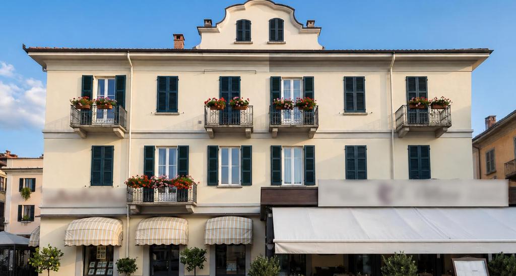 a large building with flowerpots on the windows at Residence Cosy Baveno in Baveno