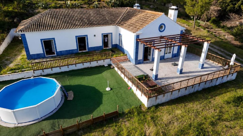 a house with a boat on the water at Casa da Lua in Erra
