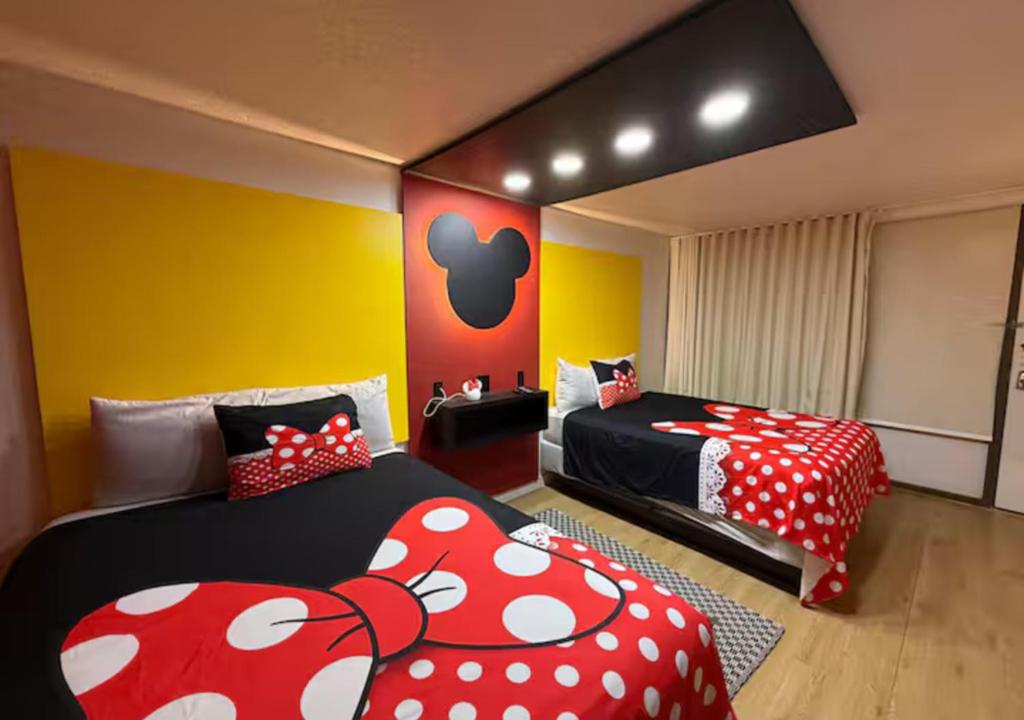 a bedroom with two beds with red and white sheets at Lyrios Vacation Rentals - Legacy in Kissimmee