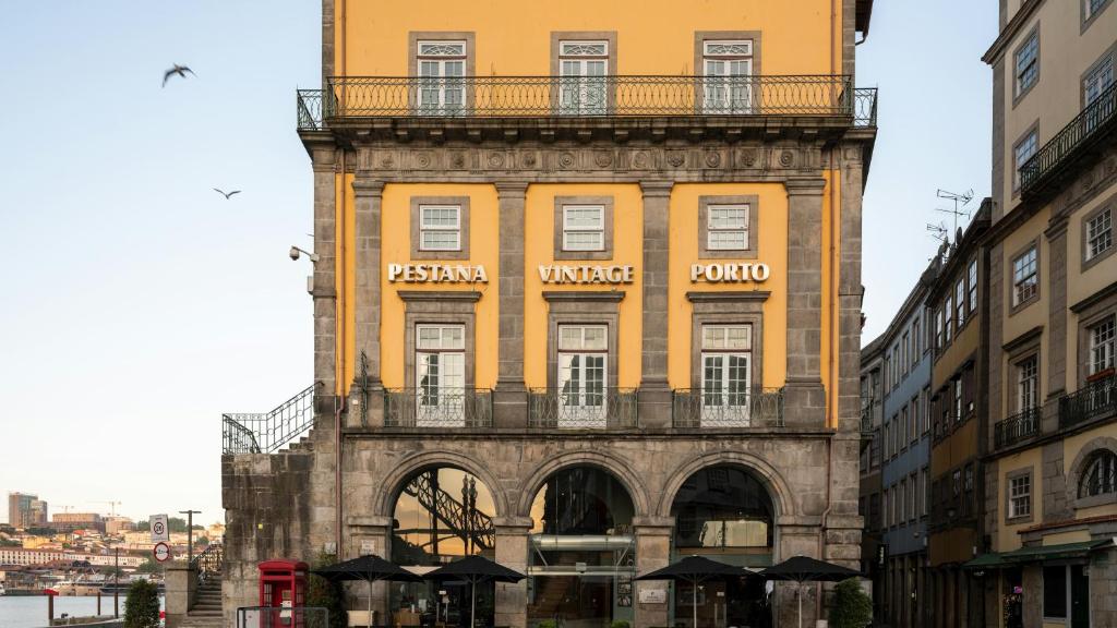 a yellow building with a balcony on top of it at Pestana Vintage Porto Hotel & World Heritage Site in Porto