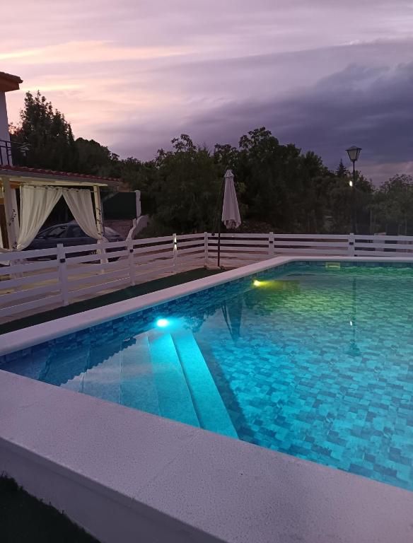 a large swimming pool with a white fence around it at Los Cabales in Torres