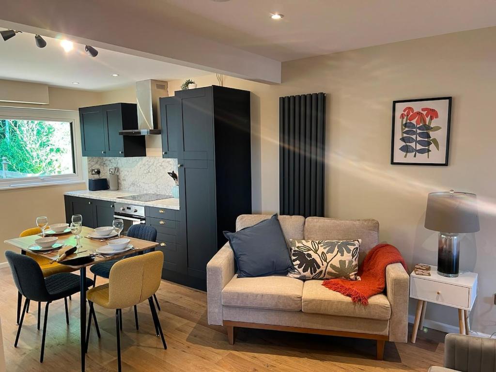 a living room with a couch and a table at Melton House in Houghton Regis