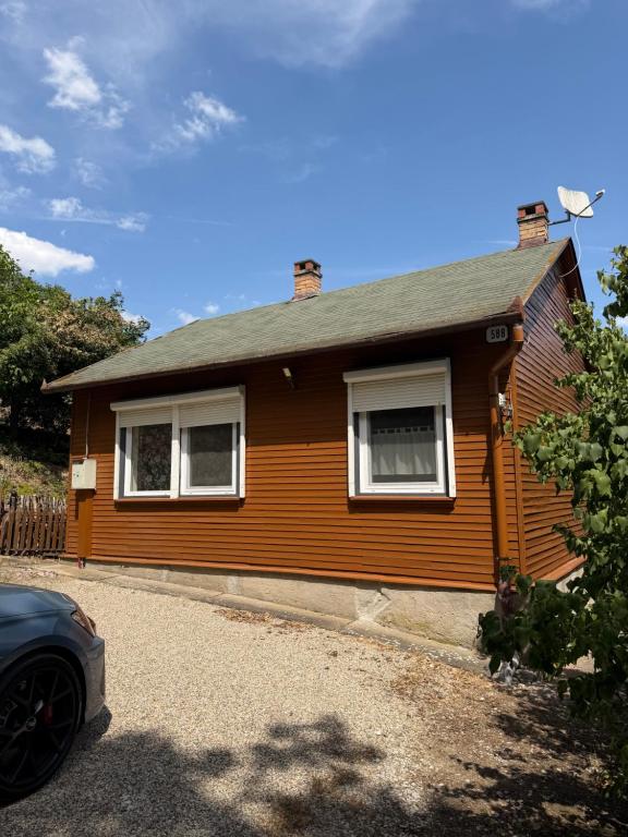 a house with a car parked in front of it at Chata Dorka in Kamenica nad Hronom