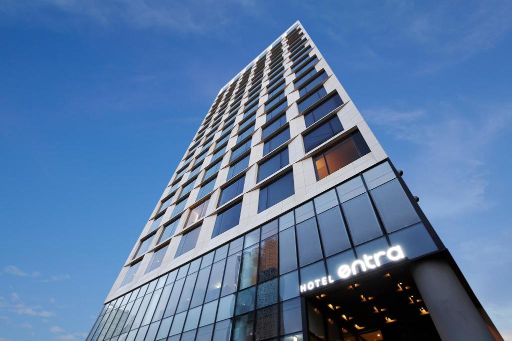 a tall building with a sign on the side of it at Hotel Entra Gangnam in Seoul