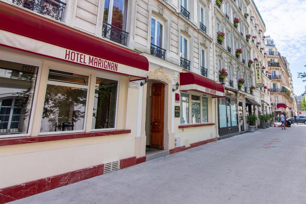 a street with a hotel written on the side of a building at Hôtel Marignan in Paris