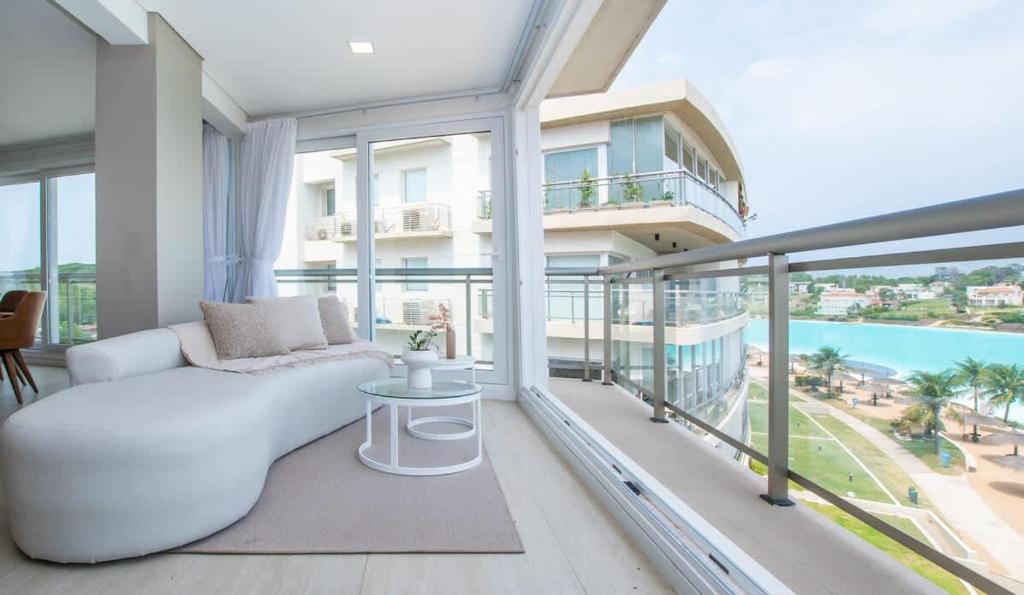a living room with a white couch on a balcony at 3BR Apartment Pool & Garage Sleeps 6 in San Bernardino