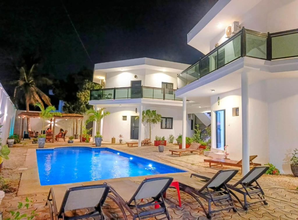 a villa with a swimming pool at night at Izuba in Ngaparou