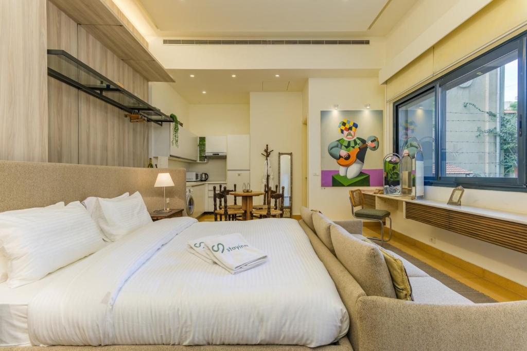 a bedroom with a large bed and a bathroom at Convivium 5 - High-end Studio in Gemmayze in Beirut