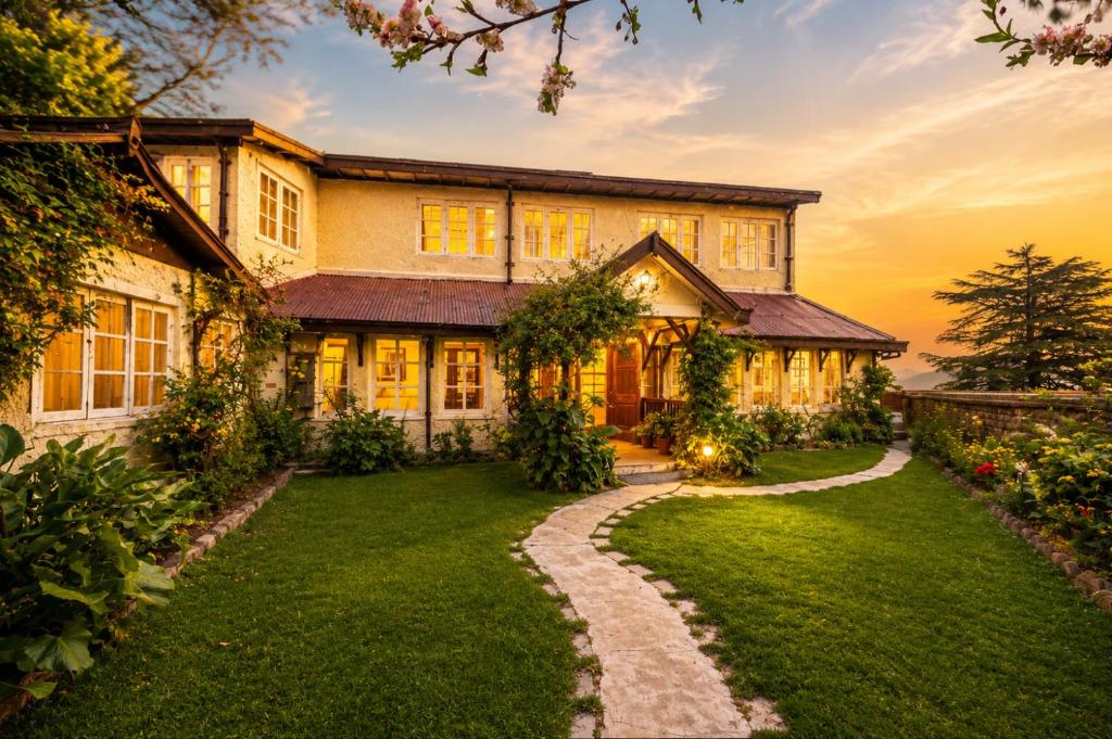 an exterior view of a house with a lawn at Springfields - A Heritage Palace Since 1902 by Eastlynn Experiences in Shimla