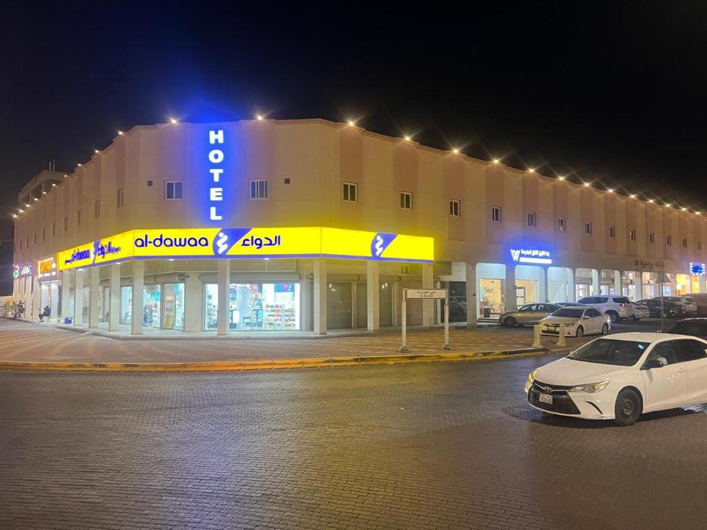 a white car parked in front of a building at night at وتد الشرق للشقق المخدومة in Khafji