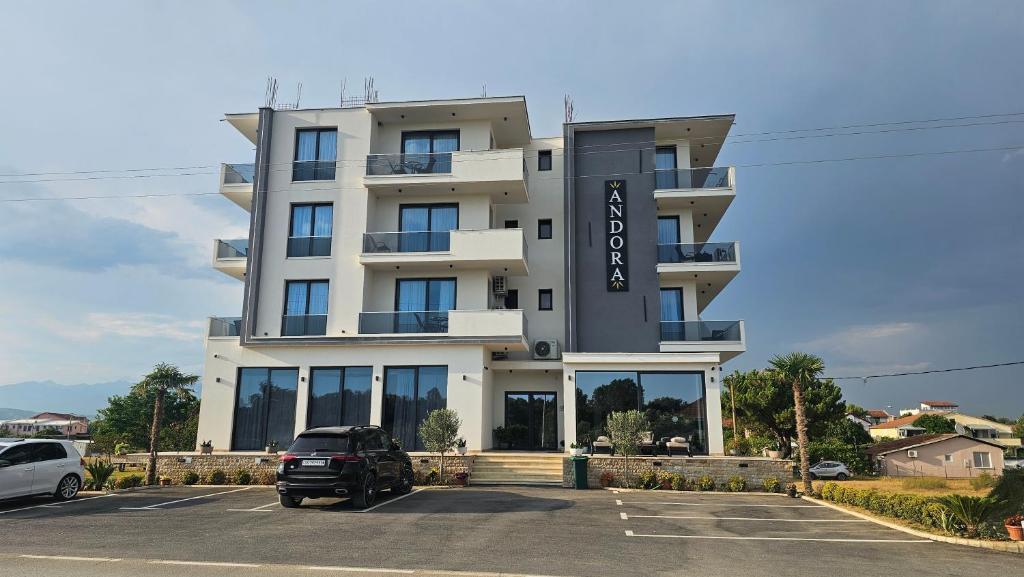 a building with a car parked in a parking lot at AnDora in Donji Štoj