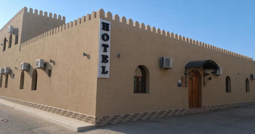 a building with a sign on the side of it at Khiva Khan in Khiva