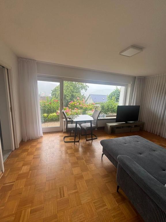 a bedroom with a bed and a table with a television at Ferienunterkunft International A in Bad Harzburg