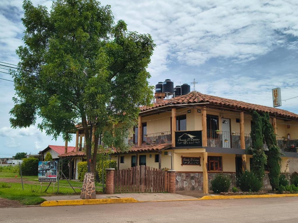 a building with a tree in front of it at Hotel Posada El Camino in Chignahuapan